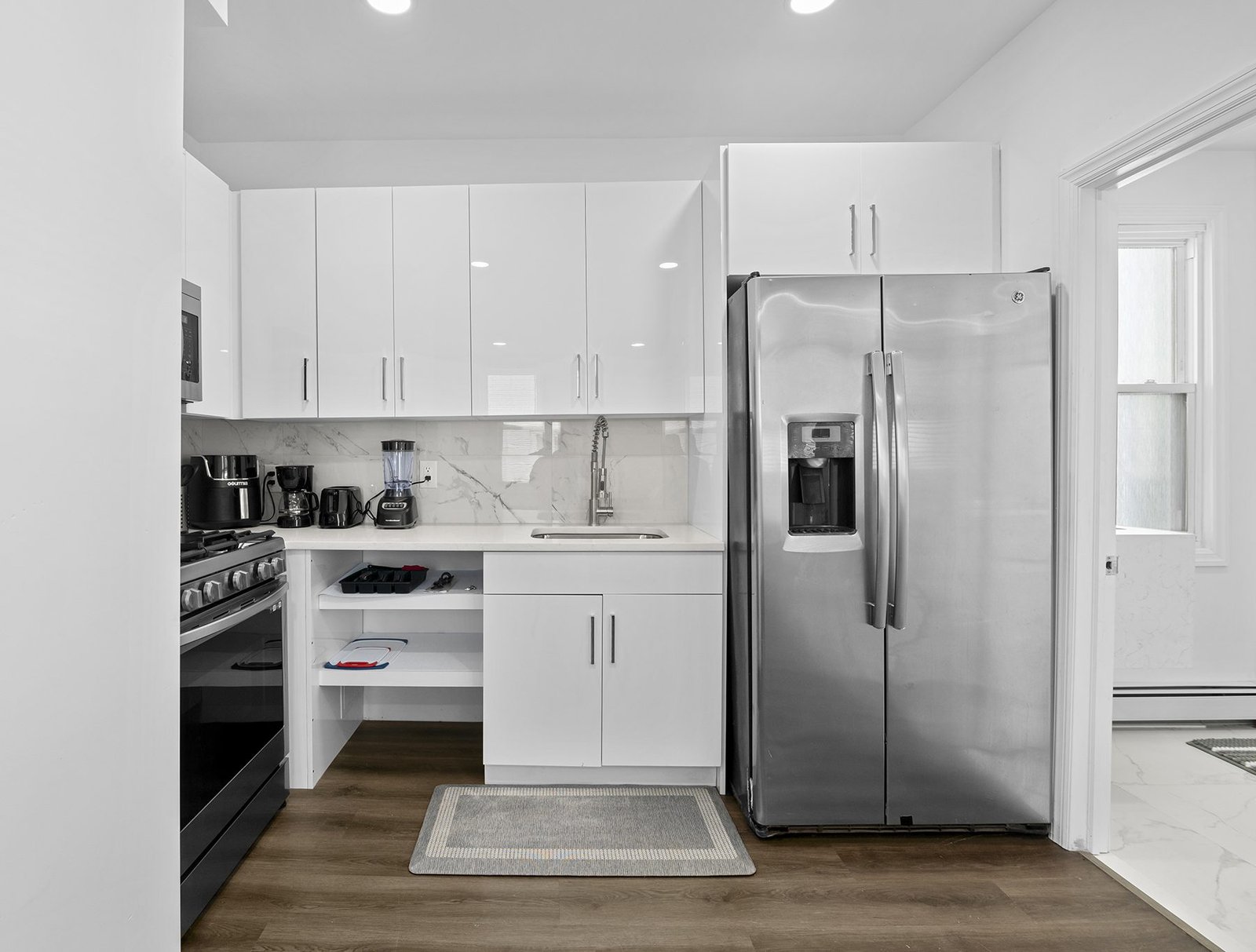 A white kitchen with stainless appliances in an iServices-managed rental